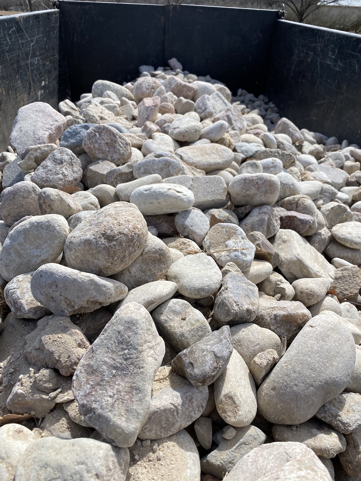 https://www.grassworksaustin.com/wp-content/uploads/2022/07/Austin-Landscape-River-Rock-2-inch-4-inch-llano.jpg