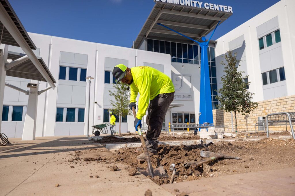 Grass Works crew providing commercial lawn care at a Georgetown, TX commercial property